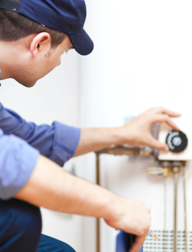 close up shot of plumber working on water heater